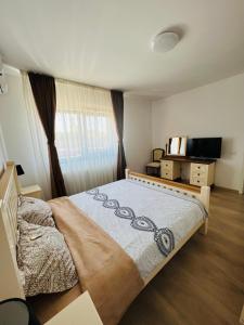 a bedroom with a large bed in a room at Dante Residence in Alba Iulia