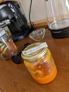 a jar of orange jam sitting on a table at Cala Vinagra House in Carloforte