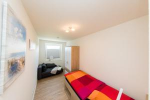 a small bedroom with a bed in a room at Quartier Hohe Geest 16 - Lena - a69851 in Cuxhaven