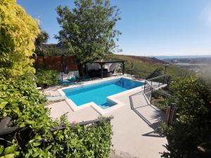 a swimming pool in a yard with a hill at Villa Diamond in Žrnovnica