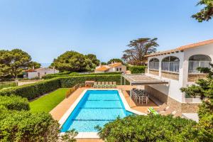 a swimming pool in the backyard of a house at Villa Pepita in Binibeca