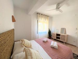 a bedroom with a bed with two towels on it at La Renda Mediterranean Villa - Beach, Jávea Port and amenities within walking distance in Jávea +97 photos
