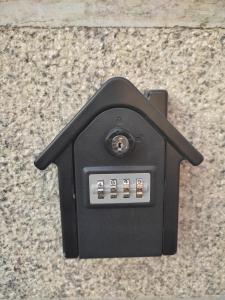 a black electrical outlet on a stone floor at Appartamento in centro Tollegno in Tollegno