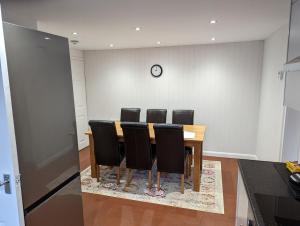 a conference room with a table and black chairs at Coach House Cottage in Runswick