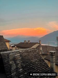 a view of the roofs of a town at sunset at Residenza Valentino in Locarno