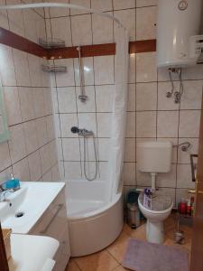 a bathroom with a tub and a sink and a toilet at APP Old Garden House in Šibenik +24 photos