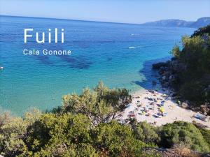 a view of a beach with people in the water at Apartment Conchiglie in Cala Gonone
