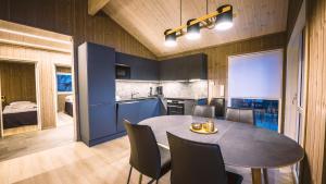 a kitchen and dining room with a table and chairs at Lakeview Vrådal Hyttegrend in Vradal