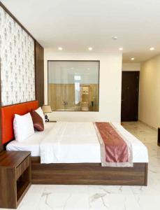 a bedroom with a large bed in a room at Hoàng Triều Hotel - Marina Bình Dương in Thu Dau Mot