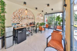 a kitchen with orange chairs and a bar in a building at Neva Kaş in Kaş