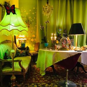 a green room with a table and a chair at La Maison des Roses in Moulins +23 photos