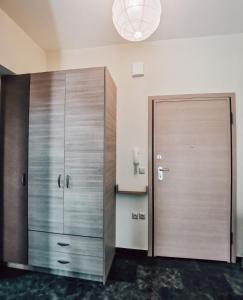 a large wooden cabinet in a room at Efrosini downtown apartment in Chalkida +7 photos