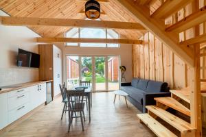 a kitchen and living room with a couch and a table at Ośrodek Wypoczynkowy Mewa in Jantar