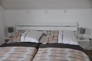 a bed with two pillows and a headboard in a bedroom at Vechtestübchen - Nordhorn in Nordhorn