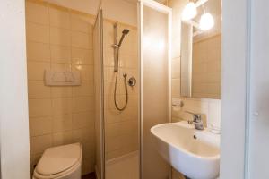 a bathroom with a shower and a sink and a toilet at Casa Ghibellina by Mmega in Florence