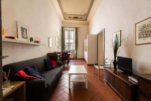 a living room with a couch and a table at Casa Ghibellina by Mmega in Florence