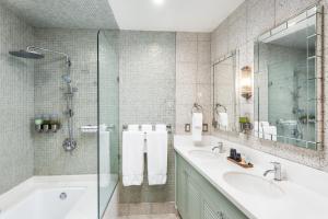 a bathroom with two sinks and a tub and a shower at National Hotel, An Adult Only Oceanfront Resort in Miami Beach