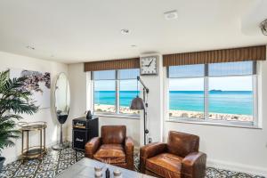 a living room filled with furniture and a window at National Hotel, An Adult Only Oceanfront Resort in Miami Beach