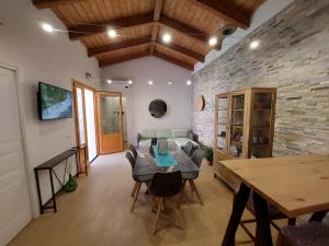 a living room with a table and a stone wall at villa Sara in Teulada