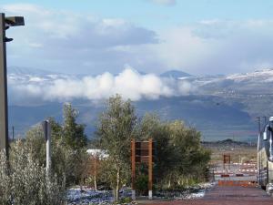 a view of a snowcovered mountain with clouds in the sky at Biktot Hamatzok - Eucalyptus in Bruchim Qela' Alon +6 photos