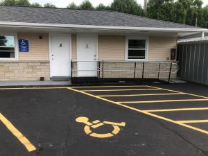 an empty parking lot in front of a house at Parkway Motel in Neenah