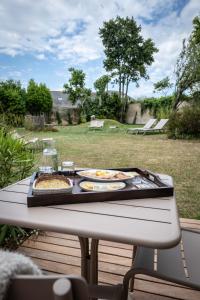 a tray of food on a table with food on it at Hotel Le Clos Fleuri in Le Palais