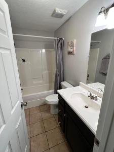 a bathroom with a white sink and a toilet at Kid-Friendly Townhouse Near Lake & Sports Complex in Guntersville +11 photos