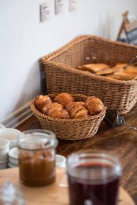 a basket of croissants and a basket of bread on a table at Hotel Le Clos Fleuri in Le Palais