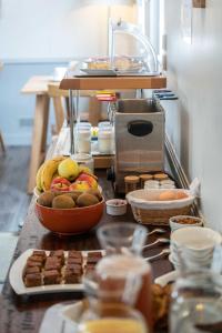 a counter with a bunch of food on it at Hotel Le Clos Fleuri in Le Palais