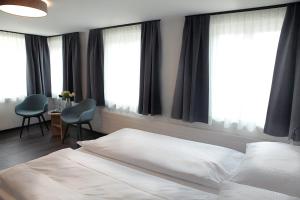 Postel nebo postele na pokoji v ubytování Dihei - Hotel, Lounge, Bar