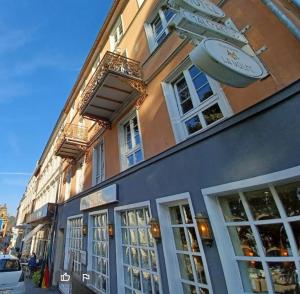 a building with a clock on the side of it at Hotel MALEPARTUS am Kurpark in Bad Schwalbach