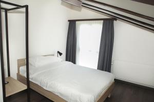 Postel nebo postele na pokoji v ubytování Dihei - Hotel, Lounge, Bar