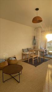 a living room with a table and a couch at Studio Le Brusc in Six-Fours-les-Plages