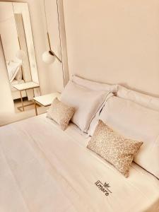 a white bed with two pillows on top of it at Il Moro Camere&Relax in San Vito lo Capo