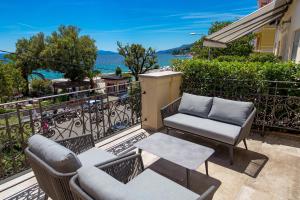 a patio with two chairs and a table on a balcony at Plaza Apartments in Opatija