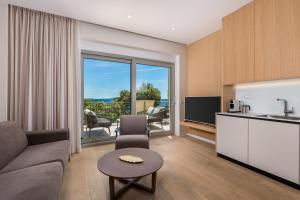 a living room with a couch and a table at Plaza Apartments in Opatija