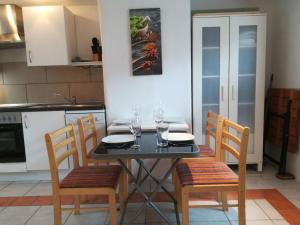a kitchen with a table with chairs and wine glasses at Ferienhuus Utarpia in Utarp