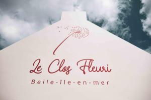 a sign for a dress house with a flower on it at Hotel Le Clos Fleuri in Le Palais