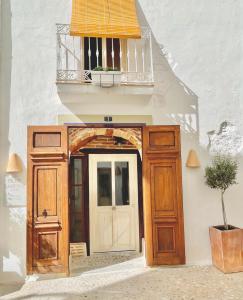 a building with a door and a balcony at Blue Sardine Hostal Boutique Altea Adults Only in Altea