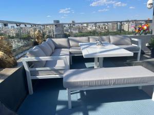 a couch and a table on a roof at PENTHOUSE COMPLEX 5 Apartments in Bucharest