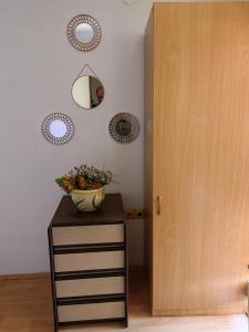 a table with a vase on it next to a door at Apartment Mirror in Visoko