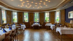 a dining room with white tables and chairs at Meyers Gasthof in Bothel