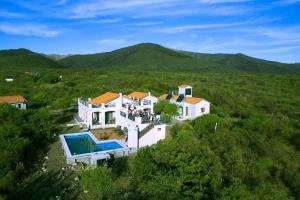 an aerial view of a large white house with a swimming pool at CasaSana Wellness in Charbonier