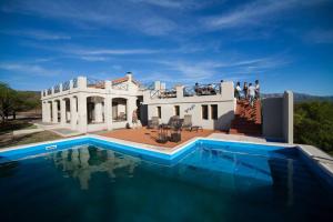 a house with a swimming pool in front of it at CasaSana Wellness in Charbonier