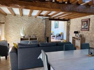 a living room with a couch and a table at Maison de Caractère in Villers-sous-Saint-Leu