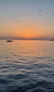 a boat in the middle of the water at sunset at Sveti Filip Jakov in Sveti Filip i Jakov