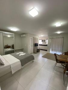 a large bedroom with a large bed and a kitchen at Paradise in Florianópolis