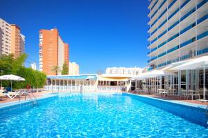 a large swimming pool in a city with buildings at Hotel Servigroup Nereo in Benidorm