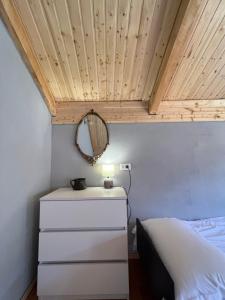 a bedroom with a bed and a wooden ceiling at Mitarbi Silence - cozy holiday cottages in mountains in Borjomi