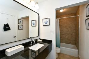 a bathroom with a sink and a mirror at Sarasota Cay Club #612 - Heated Pool, Bunk Beds, Huge TV, Tiki Bar, More! in Sarasota +21 photos